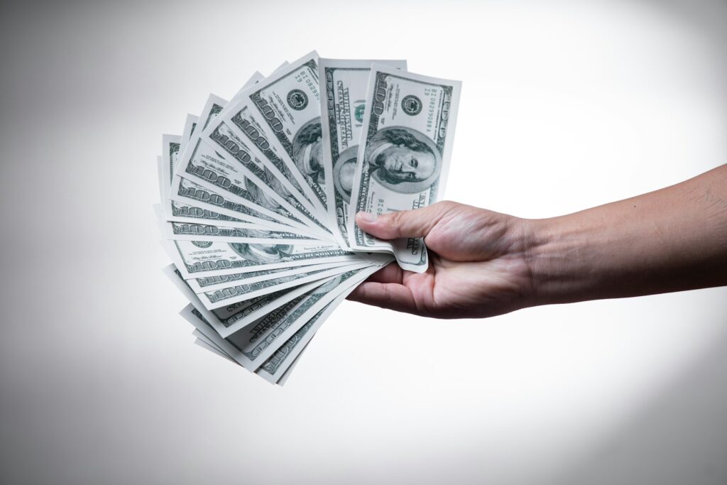 person holding 100 US Dollar banknote; side hustle income