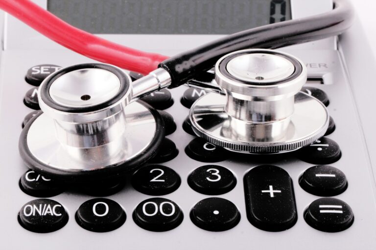 a stethoscope sitting on top of a calculator; medical debt